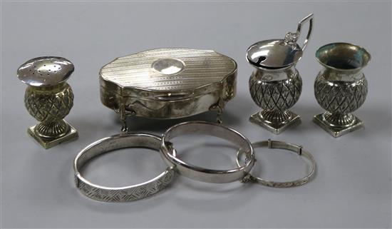 An Edwardian silver trinket box, three silver bangles and an EPNS cruet set.